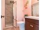 Bathroom with tiled walk-in shower, toilet, and vanity with dark wood cabinets at 521 Pinellas Bayway S # 301, St Petersburg, FL 33715