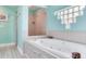 Bright, updated bathroom featuring a jacuzzi bathtub, stand-up shower, and modern decor at 521 Pinellas Bayway S # 301, St Petersburg, FL 33715