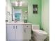 Bathroom with a white vanity, mirror, toilet, tile floor, and coastal decor at 521 Pinellas Bayway S # 301, St Petersburg, FL 33715