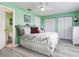Bright bedroom features a ceiling fan, coastal decor, closet, and wood-look flooring at 521 Pinellas Bayway S # 301, St Petersburg, FL 33715
