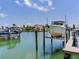 Picture perfect views of the boat lift and waterfront property with clear blue skies at 521 Pinellas Bayway S # 301, St Petersburg, FL 33715