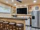 Stylish entertainment area with bar seating and built-in entertainment center at 521 Pinellas Bayway S # 301, St Petersburg, FL 33715