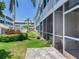 Back patio with lush landscaping that enhances privacy at 521 Pinellas Bayway S # 301, St Petersburg, FL 33715