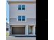 The 2-story townhome is complete with a garage and a teal door, promising a cozy living experience at 521 Pinellas Bayway S # 301, St Petersburg, FL 33715