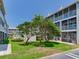 Exterior view of the property featuring mature landscaping at 521 Pinellas Bayway S # 301, St Petersburg, FL 33715
