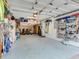 Spacious garage with overhead storage, slat wall organizer, and epoxy floor at 521 Pinellas Bayway S # 301, St Petersburg, FL 33715