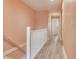Bright hallway featuring wood floors, white railings, and a fresh coat of light peach paint at 521 Pinellas Bayway S # 301, St Petersburg, FL 33715