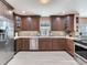 This open kitchen features stainless steel appliances, beautiful wood cabinets, and stone countertops at 521 Pinellas Bayway S # 301, St Petersburg, FL 33715