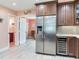 Kitchen with stainless steel refrigerator and wine cooler with a view to the next room at 521 Pinellas Bayway S # 301, St Petersburg, FL 33715