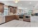 Open-concept kitchen with stainless steel appliances and view to the living room with fireplace at 521 Pinellas Bayway S # 301, St Petersburg, FL 33715
