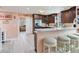 Kitchen features dark wood cabinetry, stainless steel appliances, and a breakfast bar with seating at 521 Pinellas Bayway S # 301, St Petersburg, FL 33715