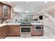 Kitchen with stainless steel oven and cooktop next to stairway to the second floor at 521 Pinellas Bayway S # 301, St Petersburg, FL 33715