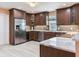 Spacious kitchen features stainless steel appliances, rich wood cabinetry, and elegant marble countertops at 521 Pinellas Bayway S # 301, St Petersburg, FL 33715
