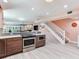 Kitchen with stainless steel oven and cooktop with stairway to the second floor at 521 Pinellas Bayway S # 301, St Petersburg, FL 33715