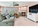 Inviting living room with a stone fireplace, comfortable seating, and a serene ambiance at 521 Pinellas Bayway S # 301, St Petersburg, FL 33715