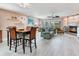 Open concept living room features cozy seating, a fireplace, and a dining area with views of the lanai at 521 Pinellas Bayway S # 301, St Petersburg, FL 33715