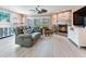 Cozy living room with plush seating, fireplace, and sliding glass doors at 521 Pinellas Bayway S # 301, St Petersburg, FL 33715