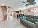 Open-concept living room with updated floors and a staircase leading to the second level at 521 Pinellas Bayway S # 301, St Petersburg, FL 33715