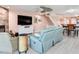 Bright living room features a ceiling fan, fireplace, comfortable seating, and staircase to the second floor at 521 Pinellas Bayway S # 301, St Petersburg, FL 33715