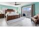 Bright main bedroom boasts a king bed, ensuite balcony, and stylish ceiling fan at 521 Pinellas Bayway S # 301, St Petersburg, FL 33715
