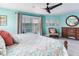 Well-lit bedroom featuring a king bed, ceiling fan, balcony access, and nice decor at 521 Pinellas Bayway S # 301, St Petersburg, FL 33715