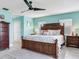 Comfortable bedroom features a large wooden bed, sleek ceiling fan, and closet at 521 Pinellas Bayway S # 301, St Petersburg, FL 33715