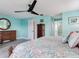 Inviting bedroom with a large wooden dresser, coastal decor, and a ceiling fan at 521 Pinellas Bayway S # 301, St Petersburg, FL 33715