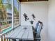 Screened-in patio features a table and chairs perfect for outdoor dining overlooking the community pool at 521 Pinellas Bayway S # 301, St Petersburg, FL 33715