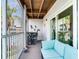 Bright screen-in patio features outdoor seating and dining area overlooking the pool and lush tropical landscaping at 521 Pinellas Bayway S # 301, St Petersburg, FL 33715