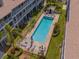 Aerial view highlighting the pool with lounging areas, palm trees, and manicured landscaping at 521 Pinellas Bayway S # 301, St Petersburg, FL 33715