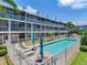 Inviting community pool with lounge chairs and umbrellas, perfect for relaxing in a serene setting at 521 Pinellas Bayway S # 301, St Petersburg, FL 33715