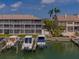 Waterfront condos with boats docked in private lifts, showcasing the community's unique boating lifestyle at 521 Pinellas Bayway S # 301, St Petersburg, FL 33715