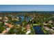 Wide aerial shot of a neighborhood with lakes and a skyline in the distance at 5242 Venice Ne Way, St Petersburg, FL 33703