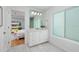 Bright bathroom with marble floors, white vanity, and frosted window, overlooking a sun-filled bedroom and pool at 5242 Venice Ne Way, St Petersburg, FL 33703