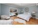 Cozy bedroom showcases pool view, neutral decor, white bedding, and hardwood floors at 5242 Venice Ne Way, St Petersburg, FL 33703