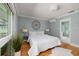 Airy bedroom with hardwood floors, decorative wall art, and view to the bathroom at 5242 Venice Ne Way, St Petersburg, FL 33703