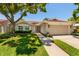 Charming home featuring a well-maintained lawn, a red tile roof, and a two-car garage at 5242 Venice Ne Way, St Petersburg, FL 33703
