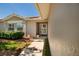 Inviting front entrance with a glass storm door and mature landscaping at 5242 Venice Ne Way, St Petersburg, FL 33703