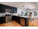 Bright kitchen with stainless steel appliances, modern granite countertops, and dark cabinets at 5242 Venice Ne Way, St Petersburg, FL 33703