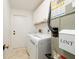 Laundry room with washer, dryer, and built-in upper cabinets for storage at 5242 Venice Ne Way, St Petersburg, FL 33703
