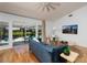 Bright living room with wood floors and a view of the screened lanai and pool at 5242 Venice Ne Way, St Petersburg, FL 33703