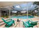 The in-ground screened pool features a tranquil view of the pond and plenty of space for relaxing at 5242 Venice Ne Way, St Petersburg, FL 33703