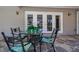 Outdoor seating area featuring a stone patio and furniture for four, overlooking the screened in pool at 5242 Venice Ne Way, St Petersburg, FL 33703