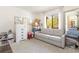 Bright room features a sofa, dresser, and window, creating a peaceful atmosphere for relaxation and comfort at 5666 Gardens Dr # 202, Sarasota, FL 34243