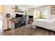 Cozy bedroom featuring a workstation, a full-sized bed, and a large window, showcasing a fusion of comfort and productivity at 5666 Gardens Dr # 202, Sarasota, FL 34243
