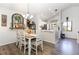 Charming dining area with rustic table, chandelier, and decor at 5666 Gardens Dr # 202, Sarasota, FL 34243