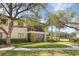 Well-maintained condo building featuring a screened in balcony, lush landscaping, and a sidewalk at 5666 Gardens Dr # 202, Sarasota, FL 34243