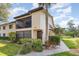 Beautiful condo building with private entrance, landscaping, and a screened in outdoor balcony at 5666 Gardens Dr # 202, Sarasota, FL 34243