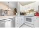 Bright kitchen featuring white cabinetry and stainless steel appliances at 5666 Gardens Dr # 202, Sarasota, FL 34243