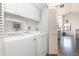 Well-lit laundry area with white washer, dryer, and cabinets, ensuring a clean and efficient space for laundry tasks at 5666 Gardens Dr # 202, Sarasota, FL 34243